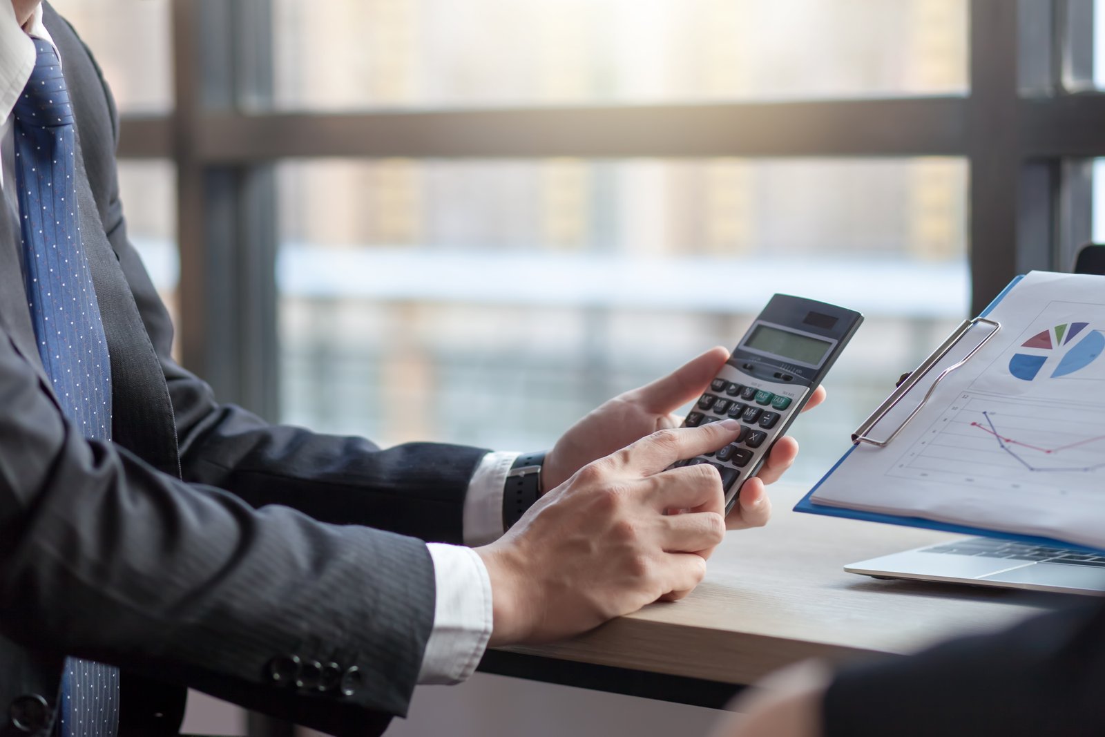 DIFC vs ADGM cost comparison being calculated by a business adviser for a founder