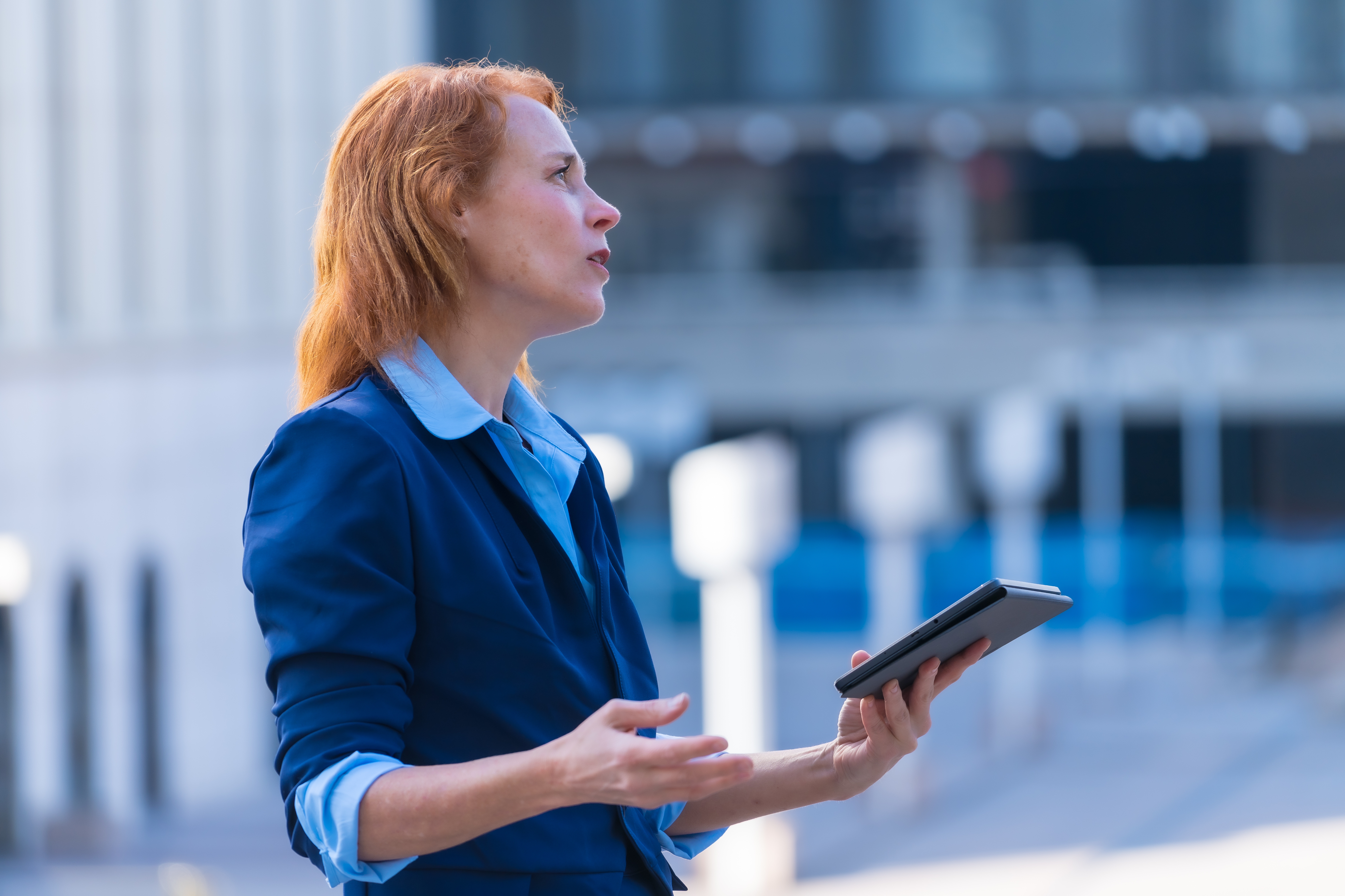 Innovative and Tech-Savvy Red-Haired Female Business Professional Collaborating with Colleagues